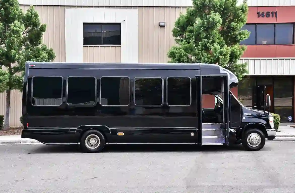 a black bus parked in front of a building