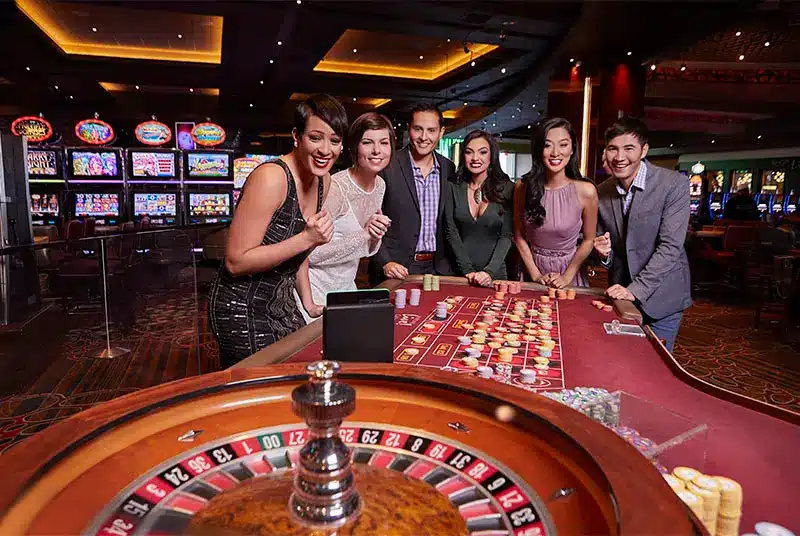 casino transportation a group of people standing around a casino table