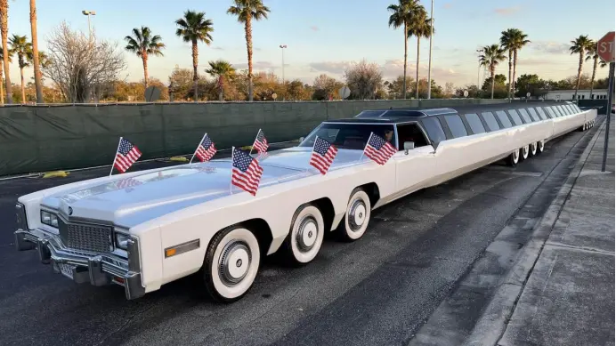 a large white limousine with american flags on it a large white limousine with american flags on it Ridiculously Long Names