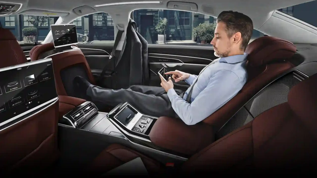 a man sitting in the driver's seat of a car