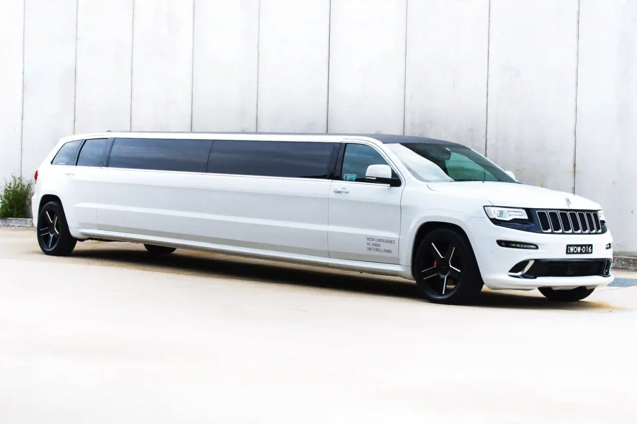 Jeep Limousine  a white limo parked in front of a building