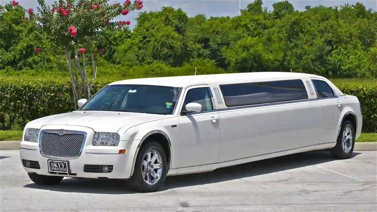  All about your limos a white limousine parked in a parking lot