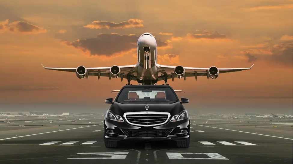 a large jetliner flying over a car on a runway